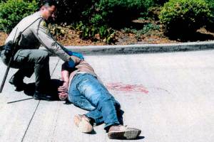 Robert Preston in 2014 on the ground at an Everett park-and-ride, where he said he was assaulted by a Snohomish County sheriff's deputy. The incident led to a lawsuit and a $150,000 settlement. (Snohomish County Sheriff's Office via federal court filing) 20210822