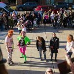 A group of adult contestants compete in a zombie-off while surrounded by a large crowd during the 10th annual Snohomish Zombie Walk on Saturday, Oct. 28, 2023, in downtown Snohomish, Washington. (Ryan Berry / The Herald)