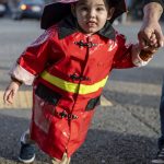 Ernest Salvator-Thaete, 2, poses for a photo during the Downtown Trick or Treat event in Monroe, Washington on Tuesday, Oct. 31, 2023. Children, teens and families walked Main Street to collect candy from local businesses. Dogs sported costumes as well and decorations adorned buildings. (Annie Barker / The Herald)