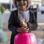 Callum, 3, poses for a photo during the Downtown Trick or Treat event in Monroe, Washington on Tuesday, Oct. 31, 2023. Children, teens and families walked Main Street to collect candy from local businesses. Dogs sported costumes as well and decorations adorned buildings. (Annie Barker / The Herald)