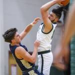 Jacksons Trey Hawkins leaps to get a rebound during the game against Arlington on Tuesday, Nov. 28, 2023 in Everett, Washington. (Olivia Vanni / The Herald)