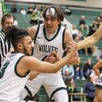 Jacksons Drew Pepin cheers on his teammate Trey Hawkins after he draws a foul during the game against Arlington on Tuesday, Nov. 28, 2023 in Everett, Washington. (Olivia Vanni / The Herald)