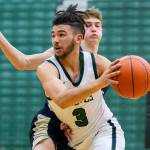 Jackson’s Trey Hawkins drives to the hoop during the game against Arlington on Tuesday, Nov. 28, 2023 in Everett, Washington. (Olivia Vanni / The Herald)