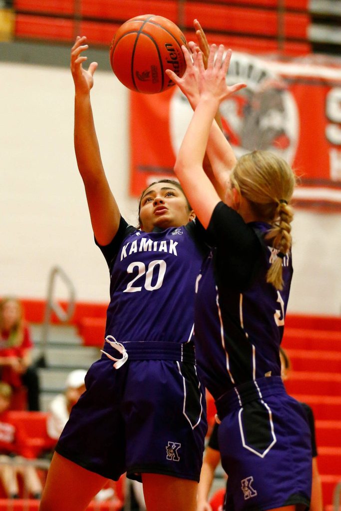 Kamiaks Synclair Mawudeku and Brooklyn Huguenin both reach for a rebound against Stanwood on Thursday, Nov. 30, 2023, at Stanwood High School in Stanwood, Washington. (Ryan Berry / The Herald)