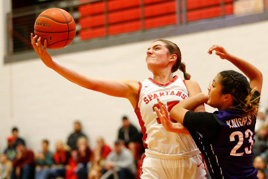 Stanwoods Stella Berrett comes down with a rebound against Kamiak on Thursday, Nov. 30, 2023, at Stanwood High School in Stanwood, Washington. (Ryan Berry / The Herald)