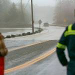 Two drivers watch as a person in a lifted Ford fords a flooded Highway 530 near Twin Rivers Park during heavy flooding on Tuesday, Dec. 5, 2023, in Arlington, Washington. (Ryan Berry / The Herald)