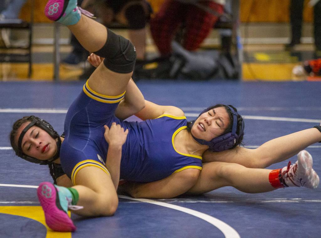 Everett and Monroe wrestlers flip around during a match on Wednesday, Dec. 13, 2023 in Everett, Washington. (Olivia Vanni / The Herald)