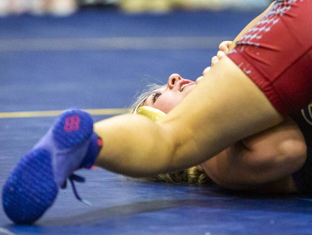 A wrestler takes a deep breath before being pinned by their opponent on Wednesday, Dec. 13, 2023 in Everett, Washington. (Olivia Vanni / The Herald)