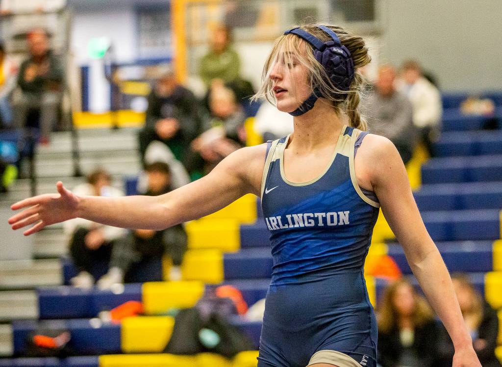Arlington’s Araxi Crew goes to shake the hand of her opponent on Wednesday, Dec. 13, 2023 in Everett, Washington. (Olivia Vanni / The Herald)