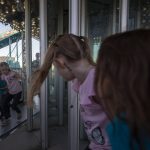 Children enter a house of mirrors during the Kla Ha Ya Days carnival at Harvey Field on Thursday, July 13, 2023, in Snohomish, Washington. (Annie Barker / The Herald)
