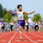 Lake Stevens runner Grant Buckmiller, a senior, throws his hands up as he wins the 4A boys 400-meter dash by more than three seconds during the WIAA State Track and Field Championships on Saturday, May 27, 2023, at Mount Tahoma High School in Tacoma, Washington. (Ryan Berry / The Herald)