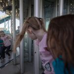 Children enter a house of mirrors during the Kla Ha Ya Days carnival at Harvey Field on Thursday, July 13, 2023, in Snohomish, Washington. (Annie Barker / The Herald)