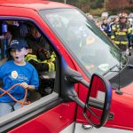 Ryan Berry / The Herald
Carson, 7, reacts as he gets an opportunity to use some of the gear inside an Everett ambulance during a surprise Make-A-Wish sendoff Oct. 21 at Thornton A. Sullivan Park in Everett. Dozens rallied together to lift up Carson before he and his family headed off to Disneyland.