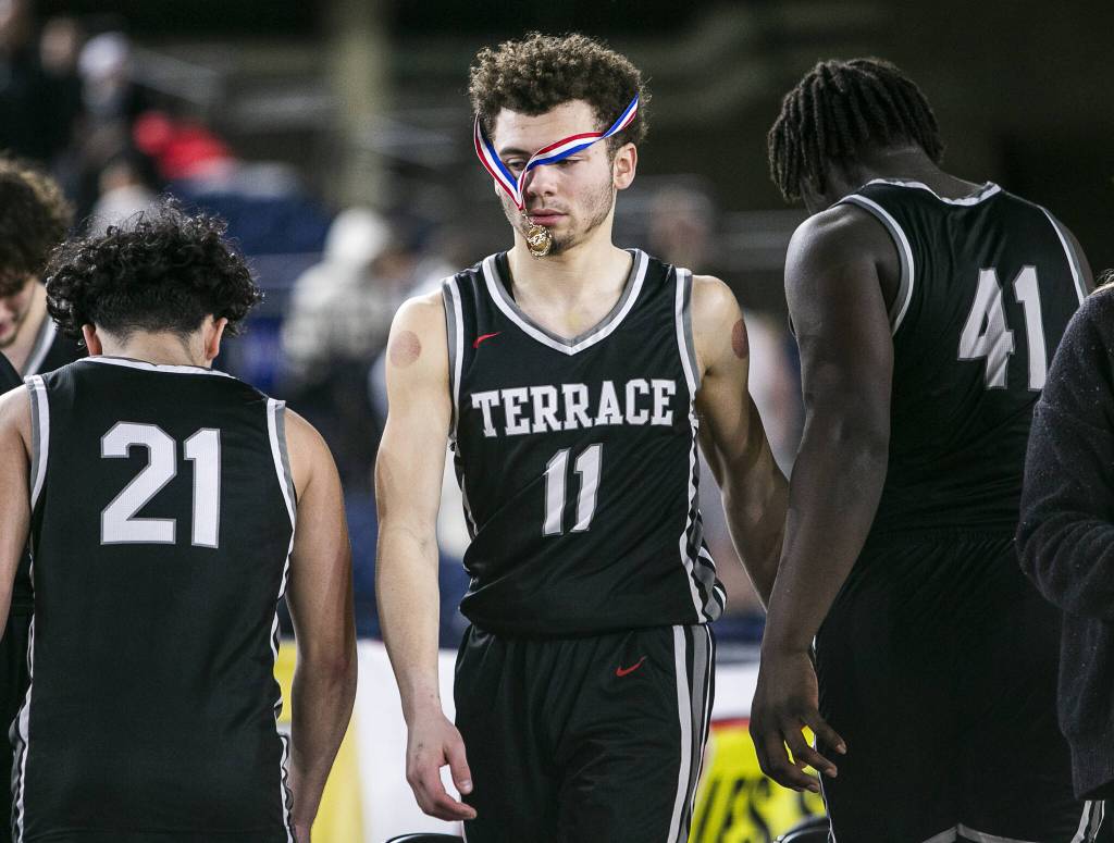 Mountlake’s Chris Meegan’s sportsmanship medal hangs over his face as his team packs up after losing to O’Dea in the 3A quarterfinal game on Thursday, March 2, 2023 in Tacoma, Washington. (Olivia Vanni / The Herald)