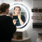 Sarah Jean Muncey-Gordon applies some BITCHSTIX lip oil. (Ryan Berry / The Herald)