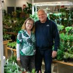 Houseplants Galore owners Carrie and Steve Compton stand amongst the foliage at their Everett Mall Way storefront on Friday, Jan. 12, 2024, in Everett, Washington. (Ryan Berry / The Herald)