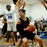 Everett Community Colleges Derek Smith tries to spin out of trouble in the lane against Edmonds College on Feb. 7 at Seaview Gym in Lynnwood. (Ryan Berry / The Herald)