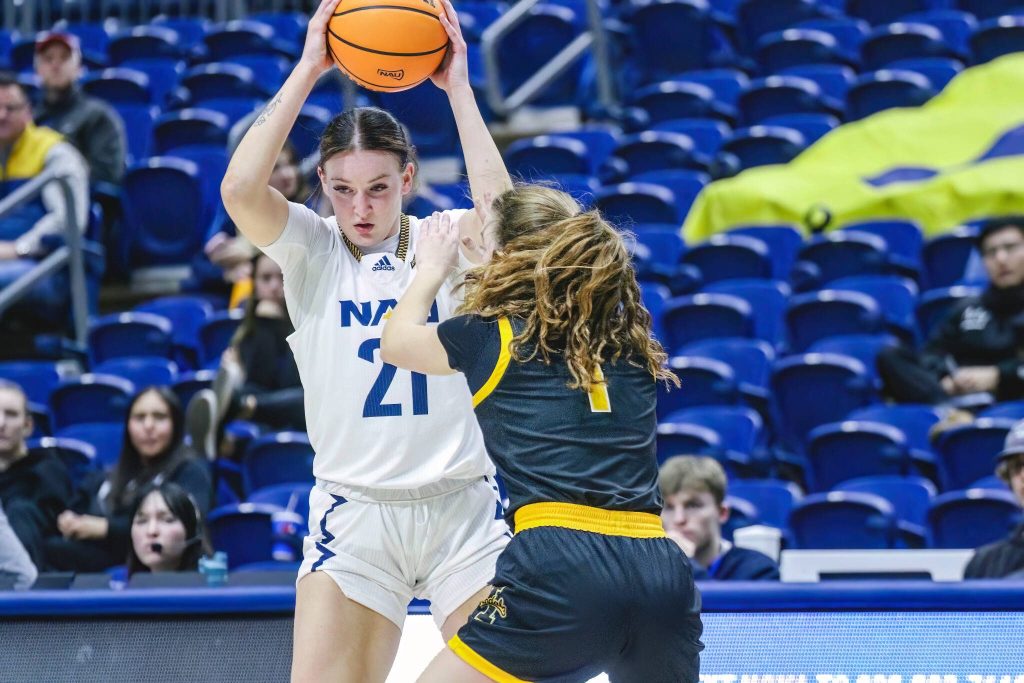 Northern Arizona Universitys Emily Rodabaugh, an Archbishop Murphy High School graduate, holds the ball high during a game in Flagstaff, Ariz. (Photo courtesy of Northern Arizona University)