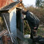 Pet detective Jim Branson leads Rafael the dog to a shed and takes a look inside before letting Rafael get a sniff on Saturday, March 2, 2024, in Everett, Washington. (Ryan Berry / The Herald)