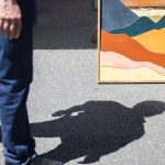 A person pauses to look at an art piece during Sorticulture on Friday, June 7, 2024, in Everett, Washington. (Olivia Vanni / The Herald)