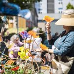 A woman picks out a glass flower from FUSE4U during Sorticulture on Friday, June 7, 2024, in Everett, Washington. (Olivia Vanni / The Herald)