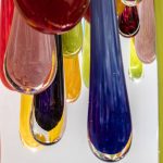Sunlight reflects through glass art at Merrilee Moore Glass during Sorticulture on Friday, June 7, 2024, in Everett, Washington. (Olivia Vanni / The Herald)