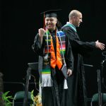 A graduate fist pumps after collecting a diploma onstage during Monroe High Schools 2024 commencement on Wednesday, June 12, 2024, at Angel of the Winds Arena in Everett, Washington. (Ryan Berry / The Herald)