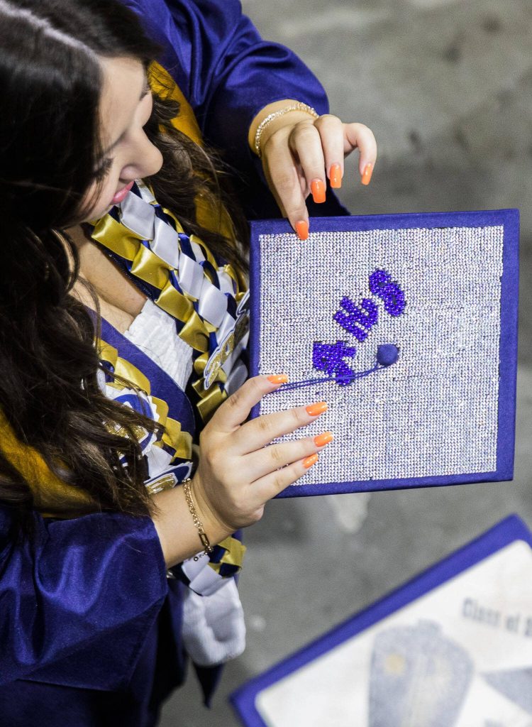 A crystal covered graduation cap shimmers during Arlington High School graduation at Angel of the Winds Arena on Thursday, June 13, 2024, in Everett, Washington. (Olivia Vanni / The Herald)
