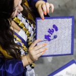 A crystal covered graduation cap shimmers during Arlington High School graduation at Angel of the Winds Arena on Thursday, June 13, 2024, in Everett, Washington. (Olivia Vanni / The Herald)