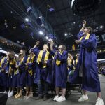 Graduates throw their caps in the air at the end of Arlington High School graduation at Angel of the Winds Arena on Thursday, June 13, 2024, in Everett, Washington. (Olivia Vanni / The Herald)