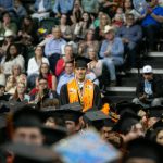Roger Rojas, a valedictorian for the Monroe High School class of 2024, stands to be recognized during commencement on Wednesday, June 12, 2024, at Angel of the Winds Arena in Everett, Washington. (Ryan Berry / The Herald)