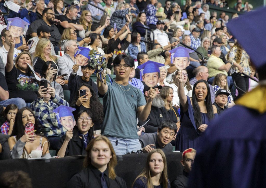 Family and friends cheer on graduates during Arlington High School graduation at Angel of the Winds Arena on Thursday, June 13, 2024, in Everett, Washington. (Olivia Vanni / The Herald)