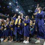 Grauates throw their caps in the air at the end of Arlington High School graduation at Angel of the Winds Arena on Thursday, June 13, 2024 in Everett, Washington. (Olivia Vanni / The Herald)