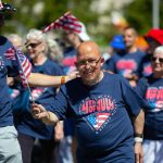 People marching with the Carl Gipson Center head down Colby during Everetts Fourth of July Parade on Thursday, July 4, 2024, in downtown Everett, Washington. (Ryan Berry / The Herald)