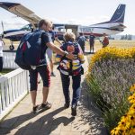 Kelly Craig places a hand on Kim Knors back as they make their way out to the plane on Wednesday, Aug. 14, 2024 in Snohomish, Washington. (Olivia Vanni / The Herald)