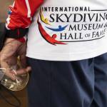Kim Knor wears her Skydiving Hall of Fame jump shirt and holds onto her goggles as she gears up before her skydive on Wednesday, Aug. 14, 2024 in Snohomish, Washington. (Olivia Vanni / The Herald)