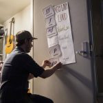 Jack White fixes a music poster in his room at Hazelwood Elementary on Aug. 26 in Lynnwood. (Olivia Vanni / The Herald)