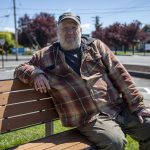 George Beard poses for a photo outside the Stanwood Library on May 8. (Annie Barker / The Herald)