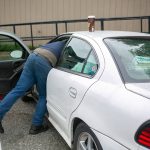 George Beard grabs something from his car while parked at the Stanwood Library on May 23. (Ryan Berry / The Herald)