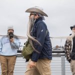 Participants in the Guinness World Record Beard Chain Attempt lineup to get their beards clipped together to be measured at Pacific Rim Plaza on Friday, Nov. 1, 2024 in Everett, Washington. (Olivia Vanni / The Herald)