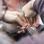 Particpants in the Guinness World Record Beard Chain Attempt have their beards clipped together on Friday, Nov. 1, 2024 in Everett, Washington. (Olivia Vanni / The Herald)
