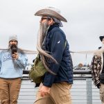 Participants in the Guinness World Record Beard Chain Attempt lineup to get their beards clipped together to be measured at Pacific Rim Park on Friday, Nov. 1, 2024 in Everett, Washington. (Olivia Vanni / The Herald)