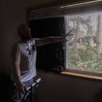 Shawn Hawes talks about barely making it out of bed before part of a tree shattered his window sending glass across his bed on Wednesday, Nov. 20, 2024 in Lake Stevens, Washington. (Olivia Vanni / The Herald)