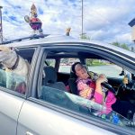 Andrea Brown / For the Herald
A woman, who identified herself as Blue, poses for a photo while sitting in a parking lot at a Safeway in Everett in July 2024.