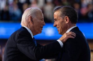 FILE — President Joe Biden embraces his son Hunter Biden after his speech on the first night of the Democratic National Convention in Chicago, Aug. 19, 2024. President Biden issued a full and unconditional pardon of his son Hunter on Sunday, Dec. 1, using the power of his office to wave aside years of legal troubles, including a federal conviction for illegally buying a gun. (Eric Lee/The New York Times)
