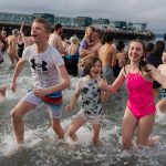 Children emerge from the cold plunge on Wednesday, Jan. 1 in Edmonds, Washington. (Will Geschke / The Herald)