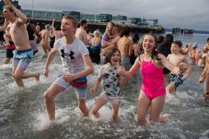 Children emerge from the cold plunge on Wednesday, Jan. 1 in Edmonds, Washington. (Will Geschke / The Herald)