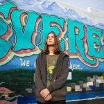 Everett P. Fog, 15, in front of an Everett mural along Colby Avenue on Wednesday, Jan. 22, 2025 in Everett, Washington. (Olivia Vanni / The Herald)