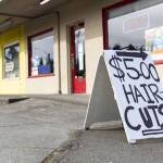 A $5 Haircuts sign sits on display along Evergreen Way in Everett. (Olivia Vanni / The Herald)
