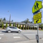 A car drives along Lockwood Road in front of Lockwood Elementary School pas the new flashing crosswalk on Monday, Sept. 30, 2024 in Bothell, Washington. (Olivia Vanni / The Herald)